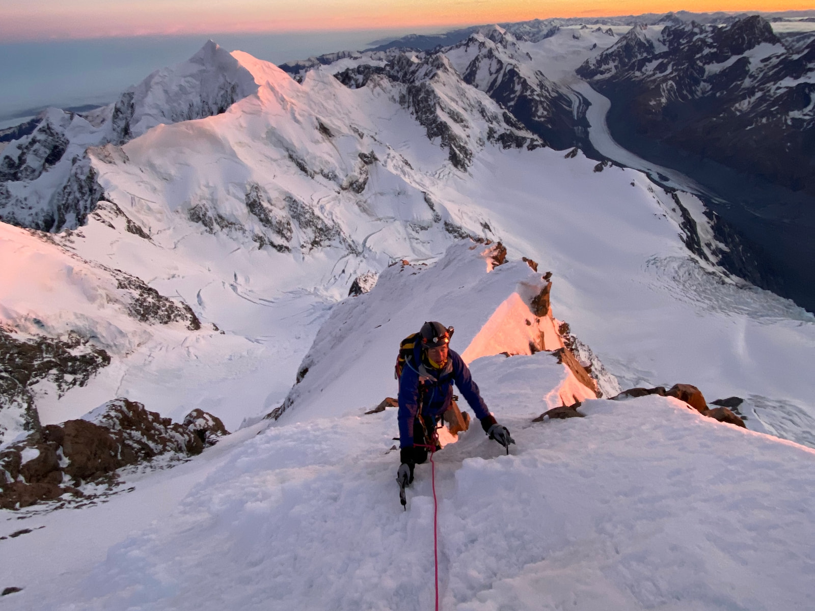 Alpinists on a steep ridge in the Alps